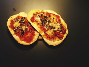 Close-up of pizza against black background