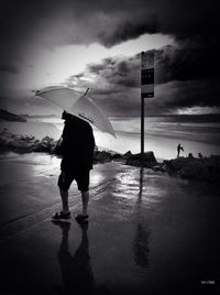 Silhouette of woman standing in water