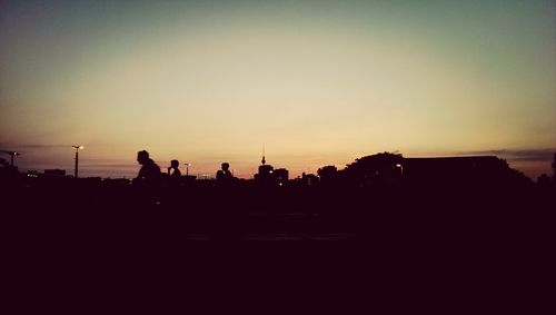 Silhouette of people at sunset