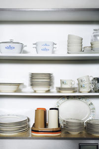 Stack of utensils arranged on rack