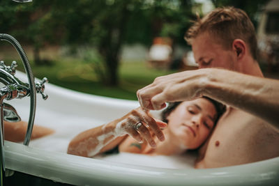 Couple in bathtub outdoors