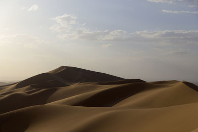 Scenic view of desert against sky during sunset