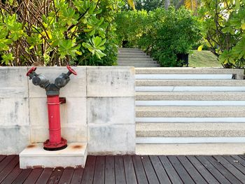 Low section of woman standing by railing