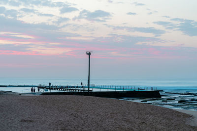 Scenic view of beach against sky during sunset