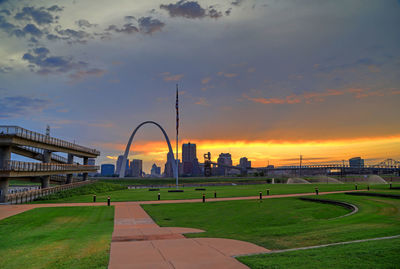 View of city against cloudy sky during sunset