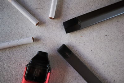 High angle view of cigarette on table against wall