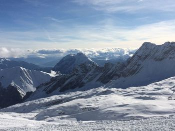 Scenic view of snowcapped mountains against sky