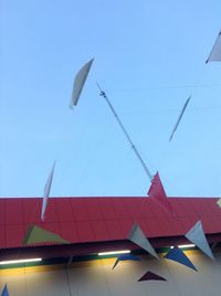 Low angle view of bird flying against blue sky