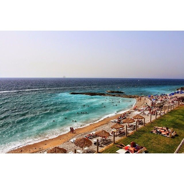 sea, horizon over water, beach, water, shore, sand, scenics, clear sky, beauty in nature, transfer print, tranquil scene, nature, vacations, tranquility, large group of people, copy space, wave, coastline, auto post production filter, sky