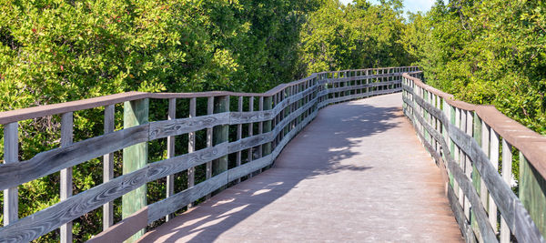 Footbridge over footpath amidst plants