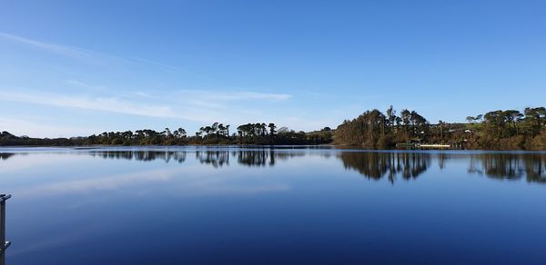 Scenic view of lake against blue sky