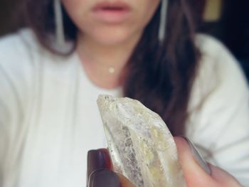 Cropped image of woman holding crystal