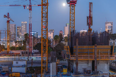 Tel aviv, israel somail complex in tel aviv in the evening with the moon rising