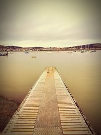 Pier over lake against sky