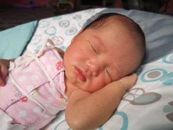 Cute baby sleeping on bed