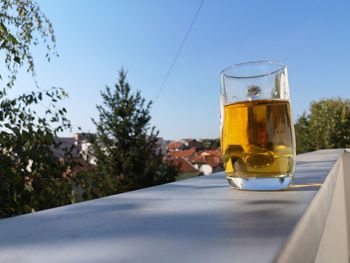 View of beer glass on table against clear sky