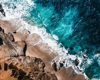 Close-up of waves splashing on rock at beach