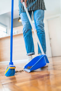 Low section of woman standing on hardwood floor