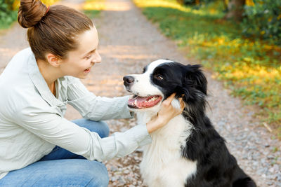 Side view of woman with dog