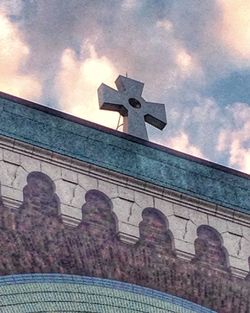 Low angle view of church against cloudy sky