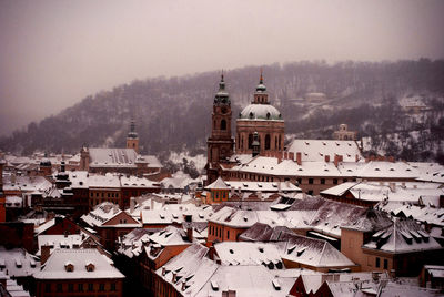 St nicholas church and houses in city during winter