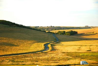 Country road passing through field