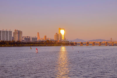 View of buildings in city at sunset