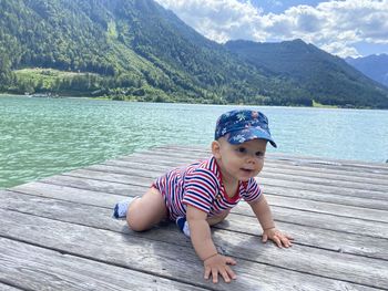 Cute baby boy against sea