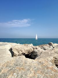 Scenic view of rocks in sea against sky