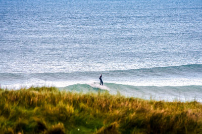 Person surfing on sea