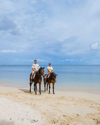 Man and woman sitting on horse