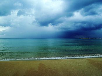 Scenic view of sea against storm clouds