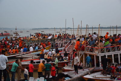 Group of people in the sea against clear sky