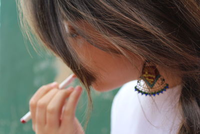 Close-up of woman holding hair