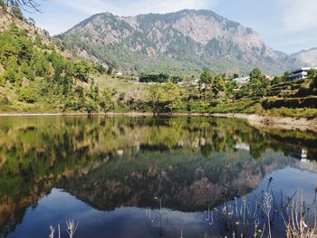 Scenic view of lake and mountains against sky