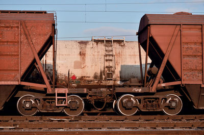 Old train on railroad track against sky