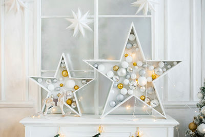 Christmas decor in the living room stars with filled christmas balls in them