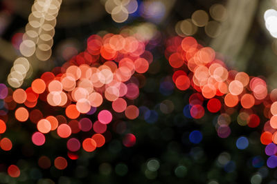 Defocused image of illuminated christmas lights at night