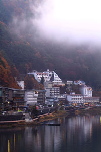 River amidst buildings in city against sky