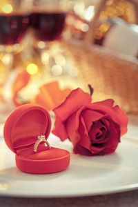 Close-up of red rose on table