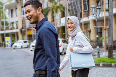 Side view of young man walking on street