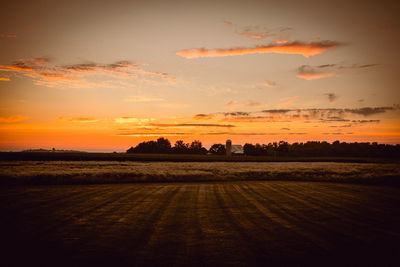 Scenic view of field against sky during sunset