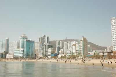 Buildings in city against clear sky