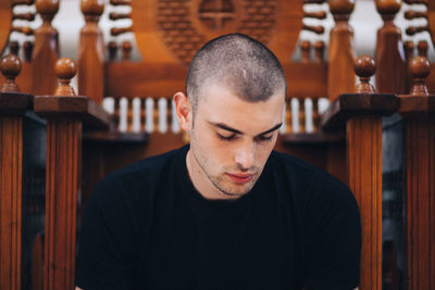 Close-up of young man sitting in church