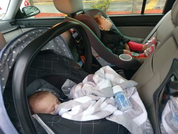 Siblings sleeping in car