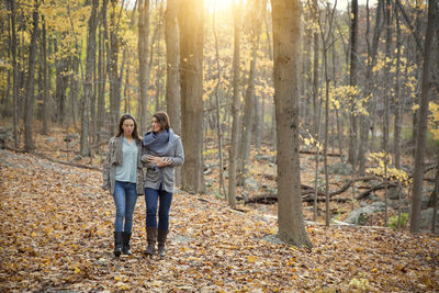 Rear view of woman standing in forest