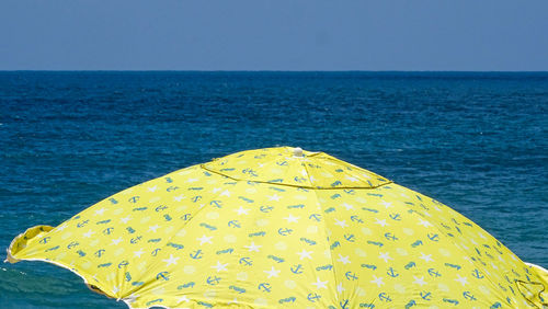 Close-up of yellow sea against clear sky