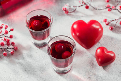 Red cocktail, vodka or liqueur and heart shape decorations