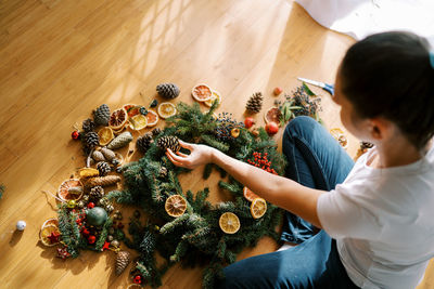 High angle view of girl decorating christmas tree