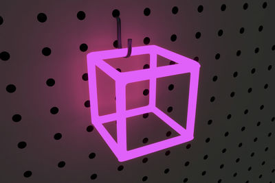 Illuminated cube shape on pegboard